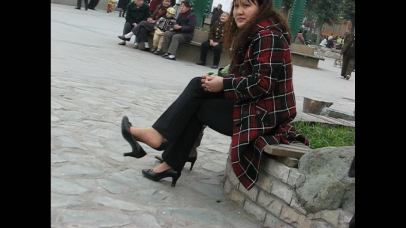 Long hair and legs dangling in the park